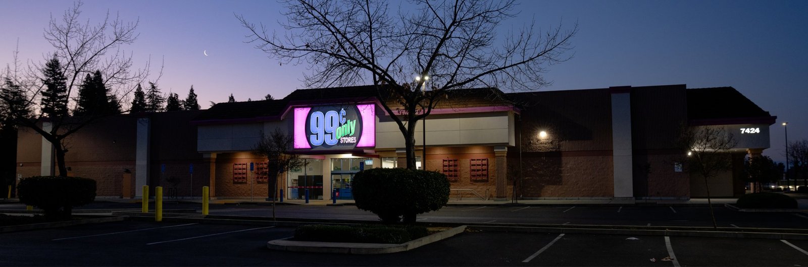 Panorama of a 99 Cents Only store and parking lot at dusk